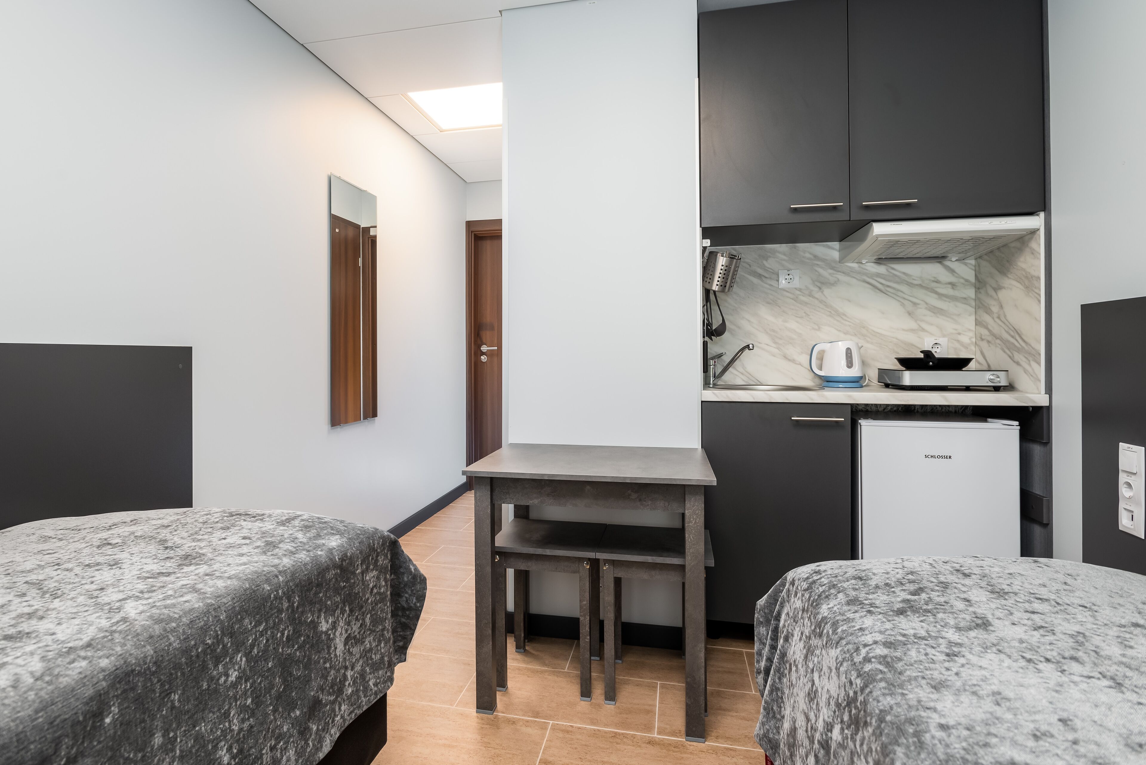 mini-fridge, microwave, stovetop, electric kettle