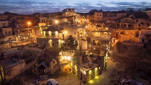 A historic town with stone buildings, a central square, and a prominent church with a bell tower. - Cappadocia Old Houses (Ürgüp)