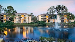 A tranquil lakeside view with a fountain, reflecting the buildings and trees. - Sheraton Vistana Resort in Orlando, Florida (includes Christmas weekend) (Orlando)