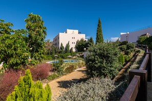 Guests can enjoy a serene garden and pool area surrounded by lush greenery.