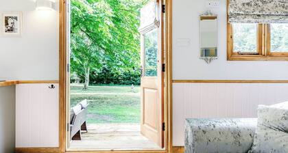 A lovely shepherd’s hut, set quietly in a paddock with shade from mature trees.