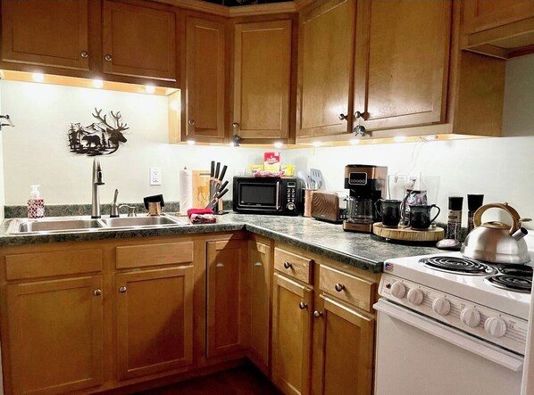 Enjoy cooking in this well-equipped kitchen with a stove, microwave, and toaster.