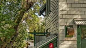 A house with a green door, a mailbox, and a white picket fence. - Tranquil Family Home located in Surfman's Walk; private crofter with shoals access (Bald Head Island)