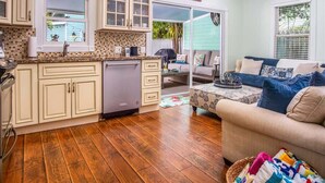 A compact living space with a kitchen, dining area, and a sofa. - Runaway Bills (Key West)