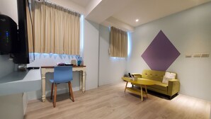 A modern living room with a desk, a sofa, and a television. - Stay a moment inn (Luodong)