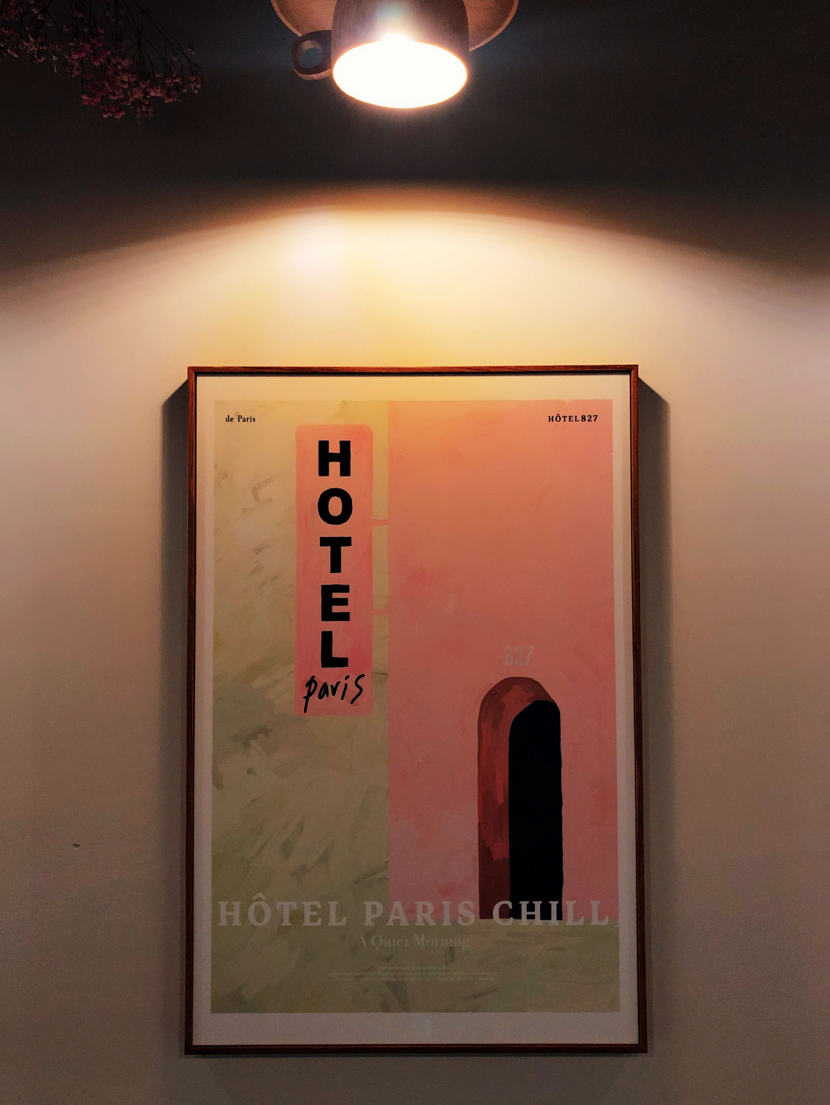 A framed poster of a hotel with the name 'HOTEL PARIS' and 'HOTEL 827' visible.