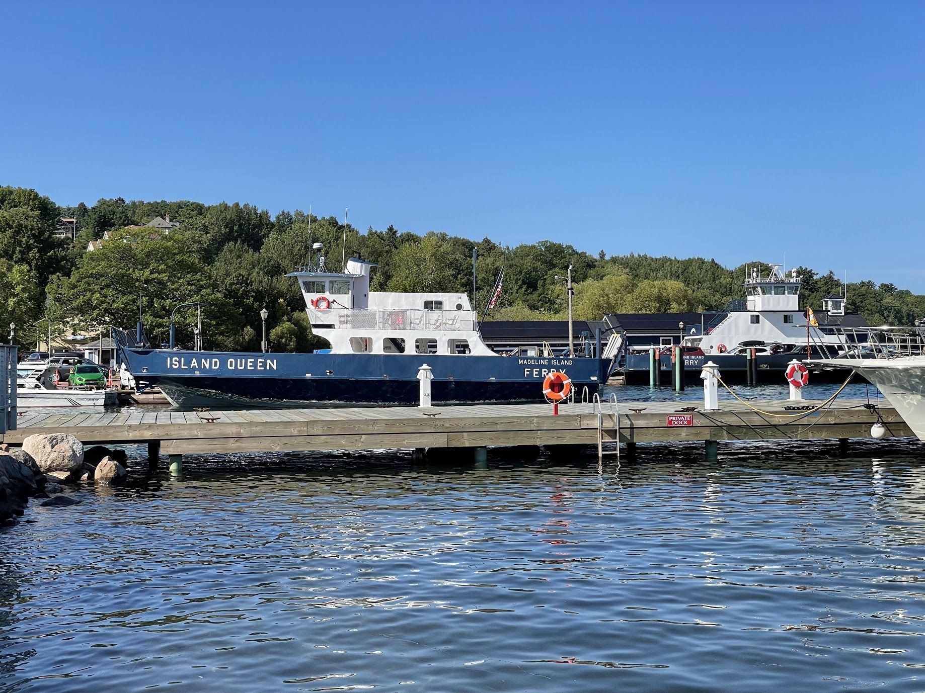 A docked ferry named 'Island Queen' with a lifebuoy and a 'Private Dock' sign.