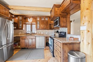 Enjoy cooking in this fully equipped kitchen with a refrigerator, microwave, oven, and dishwasher.