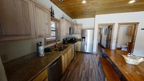 Enjoy cooking in this well-equipped kitchen with a refrigerator, microwave, and dishwasher.