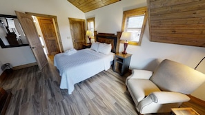 Relax in this inviting space with a large bed, two bedside tables, and a comfortable sofa.