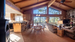 A spacious living room with a fireplace, a dining area, and a large window offering a view of the outdoors. - ❤❤❤Tahoe Vacation Stay w/Lake Views/Next to Casinos❤❤❤ (Stateline)