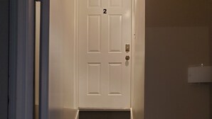 A staircase leading to a white door with the number 2 on it.