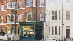 A row of terraced houses with a shop in the middle. - St Martins Square Apartment 3 (Scarborough)