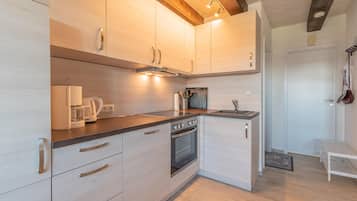 Fridge, stovetop, dishwasher, coffee/tea maker