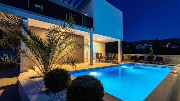 A modern house with a swimming pool, outdoor seating, and a view of the surrounding landscape. - Awesome apartment in Obrovac (Obrovac)