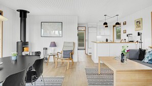 A modern kitchen with white cabinets, a black stove, and pendant lights. - Awesome home in Faaborg with WiFi (Faaborg)