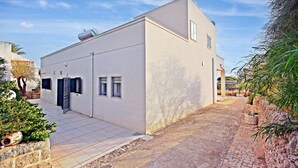 A modern building with a flat roof, a small attached garage, and a paved driveway. - Lovely home in Cava D'aliga with house sea view (Cava D'aliga)