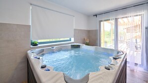 Un jacuzzi con vistas a un edificio y un balcón.
