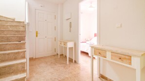 A hallway with a staircase, a door, a desk, and a bed in the background. - Awesome home in Alacant with WiFi (Alacant)
