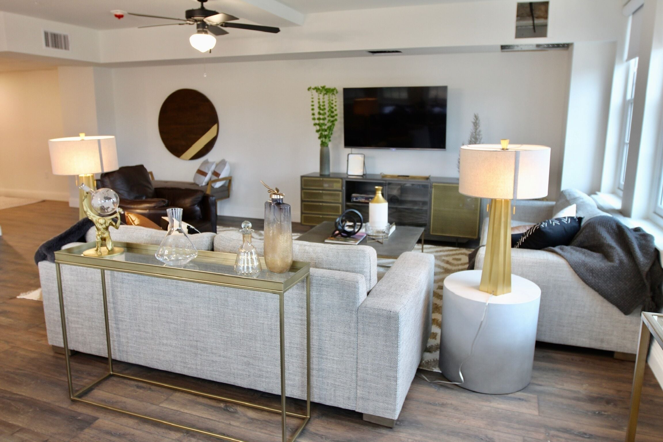 A modern living room with a sofa, coffee table, and TV.
