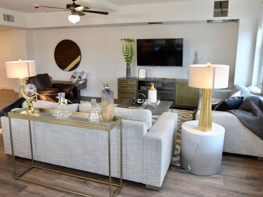 A modern living room with a sofa, coffee table, and TV.
