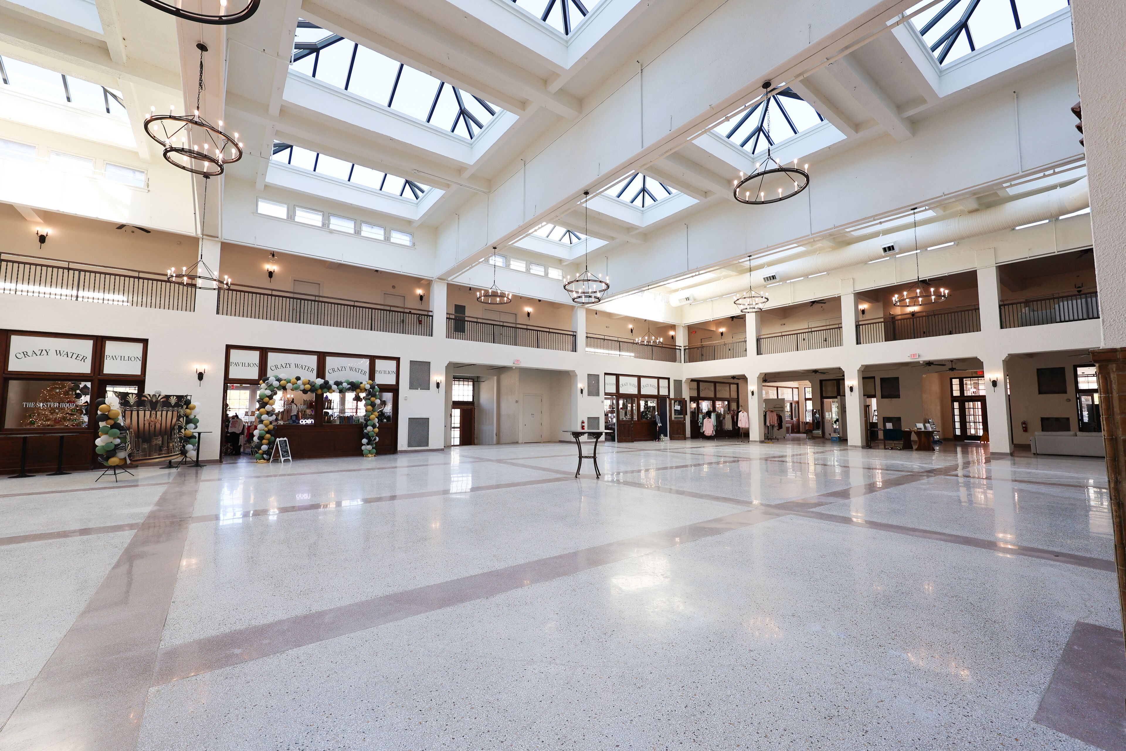 A spacious atrium with multiple levels, skylights, and a polished floor.