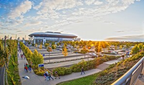 A stadium with a modern design, surrounded by a parking area and pedestrian pathways. - eXo Square Heidelberg-Schwetzingen - By SuperFly Hotels (Schwetzingen)