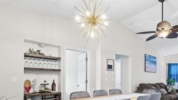 A modern living room with a dining area, a ceiling fan, and a chandelier. - New Listing!! Gulf Coast beaches, 14 min to ManasotaKey, private heated pool! (Englewood)