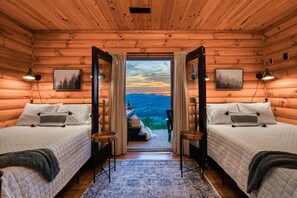 A log cabin room with two beds, a view of mountains, and a wooden ceiling. - Secluded cabin | Epic mountain views + hot tub (Sevierville)
