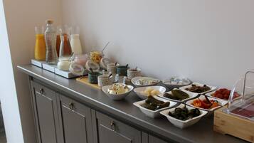 A buffet with various food items and beverages.