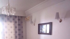 A living room with a sectional sofa, a coffee table, a TV, and a radiator. - S+1 in the tourist zone (Sousse)