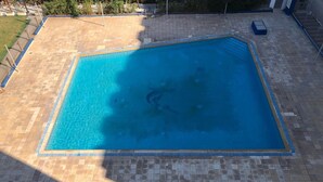 An aerial view of a rectangular swimming pool with a tiled deck surrounding it. - S+1 in the tourist zone (Sousse)