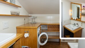 Bathroom features a washing machine, vanity with sink, and mirror.