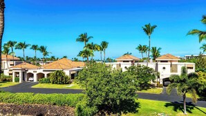 A resort with multiple buildings, palm trees, and a clear blue sky. - Shores at Waikoloa Beach Resort 315 (Waikoloa)