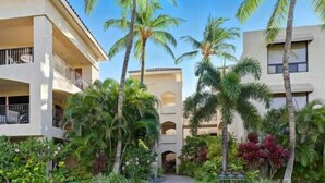 A hotel with a central courtyard, surrounded by lush greenery and palm trees. - Shores at Waikoloa Beach Resort 236 Golf Views (Waikoloa)