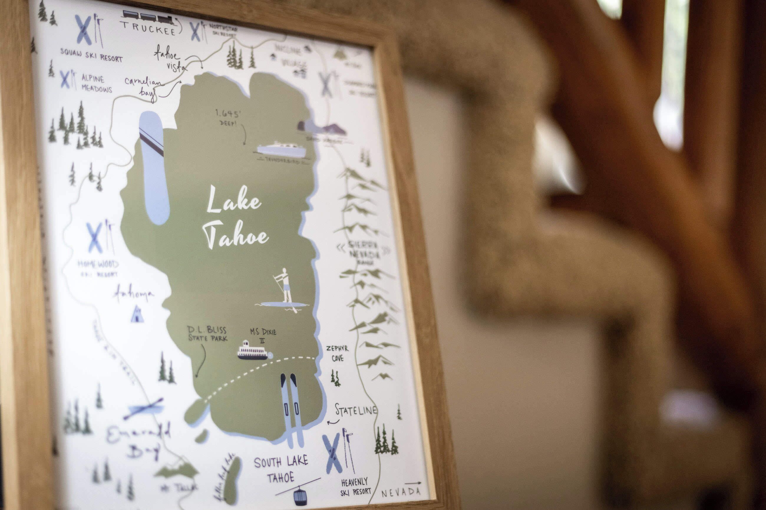 A framed map of Lake Tahoe highlighting attractions like Squaw Ski Resort, Alpine Meadows, and Heavenly Ski Resort.