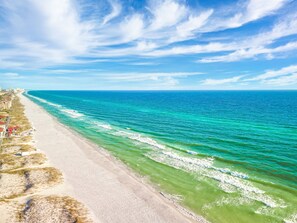 A coastal beach with a clear sky and calm sea.