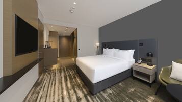 A modern hotel room with a large bed, bedside table, lamp, and a TV mounted on the wall.