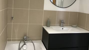 Bathtub, hair dryer, towels, soap
