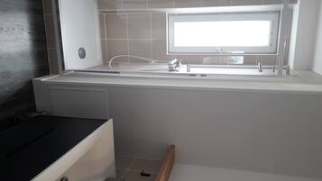 Bathtub, hair dryer, towels, soap