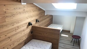 A small, compact room with a loft-style bed and a single bedside table. - 4-6 Pers apartment in the heart of the Chartreuse at the foot of the ski slopes (Sarcenas)