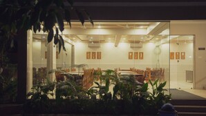 A modern hotel lobby with a glass entrance, wooden furniture, and indoor plants. - Sterling Gir (Mendarda)