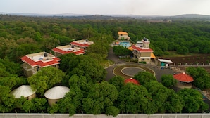 An aerial view of a resort with multiple buildings, a swimming pool, and lush greenery. - Sterling Gir (Mendarda)