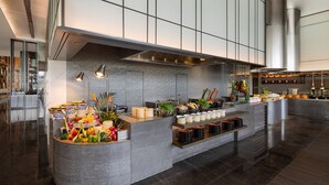 A modern kitchen with a central island, stainless steel appliances, and a variety of food items displayed. - Crowne Plaza Qingdao Jinshui by IHG (Qingdao)