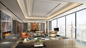 A spacious living room with a high ceiling, modern furniture, and a large window offering a city view. - Crowne Plaza Qingdao Jinshui by IHG (Qingdao)