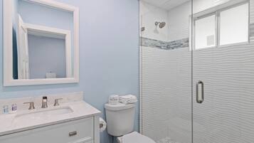 Shower, hair dryer, towels, shampoo