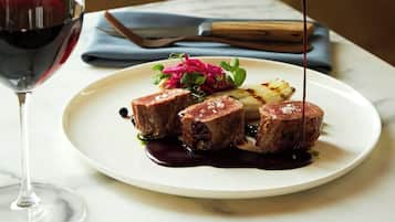 A plate of food with a sauce being poured over it.