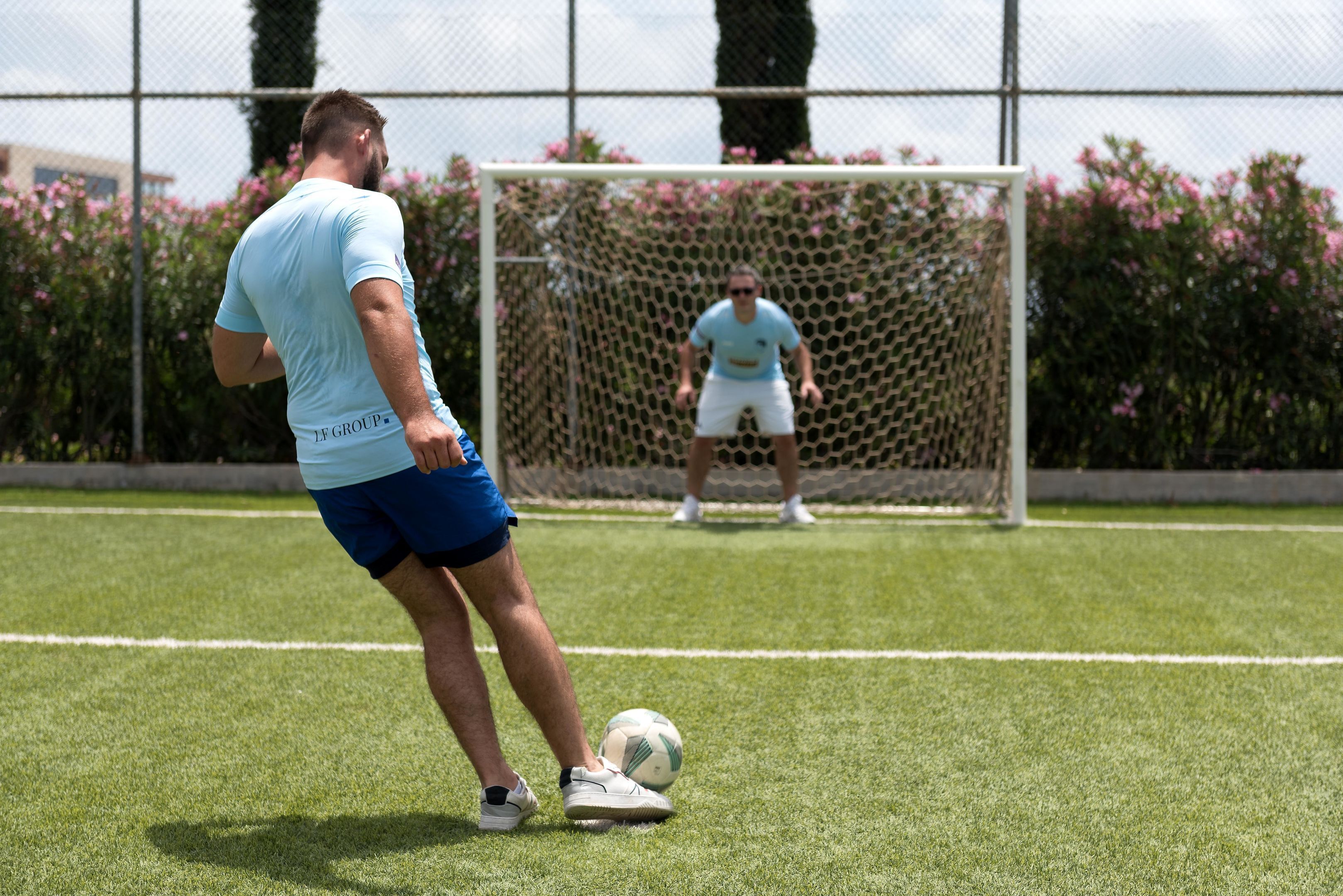 A soccer field with a goalpost and a net.
