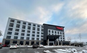 A Times Hotel building with a modern design, featuring a prominent Times sign on the facade. - Grand Hôtel TiMES Blainville - Mirabel (Blainville)