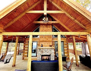 A log cabin with a stone fireplace, wooden deck, and outdoor seating area. - NEW Owl and Moon Romantic Cabin Majestic Views for Miles Fireplace and Hottub (Mentone)